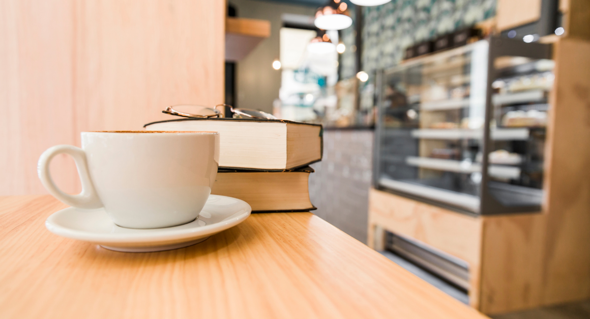 Coffee shop snack counter and a cup of coffee on the table