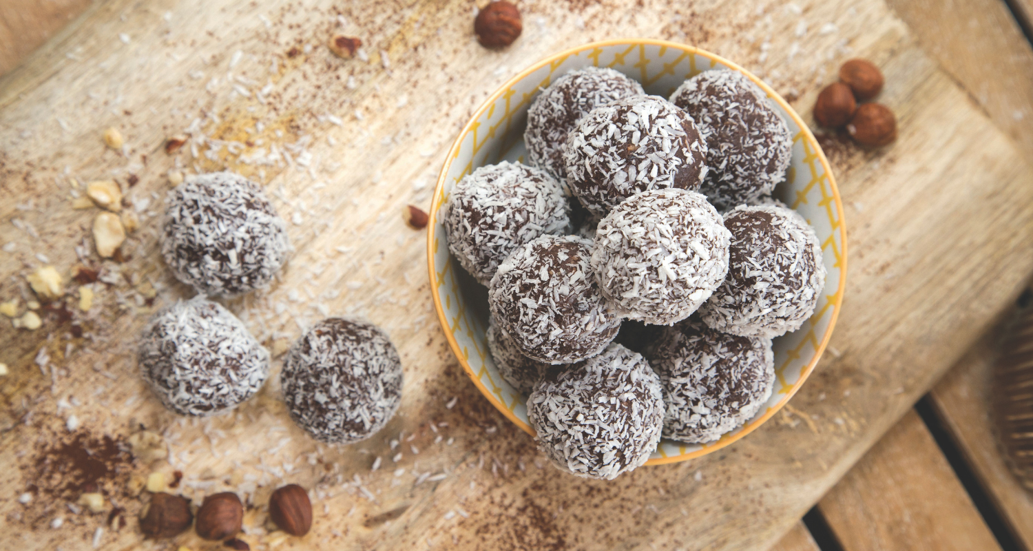 Jo’s Absolute Nutrition protein balls in a bowl on a wooden table